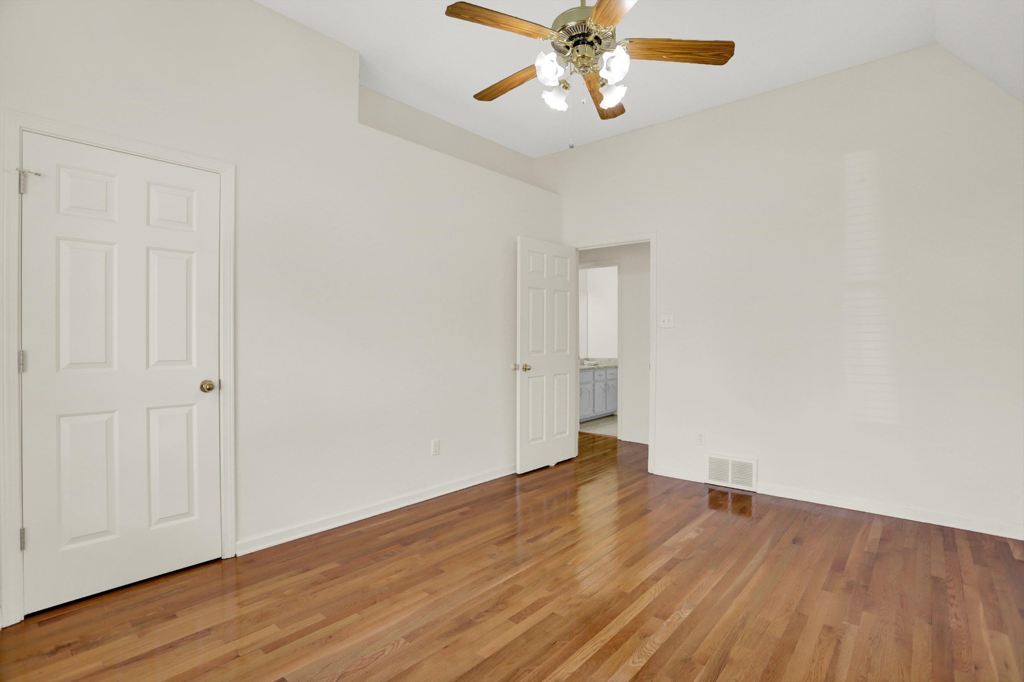 1130 Sugar Lane Collierville, TN 38017 - Photo 22 of 29 an empty room with wooden floor chandelier fan and closet area