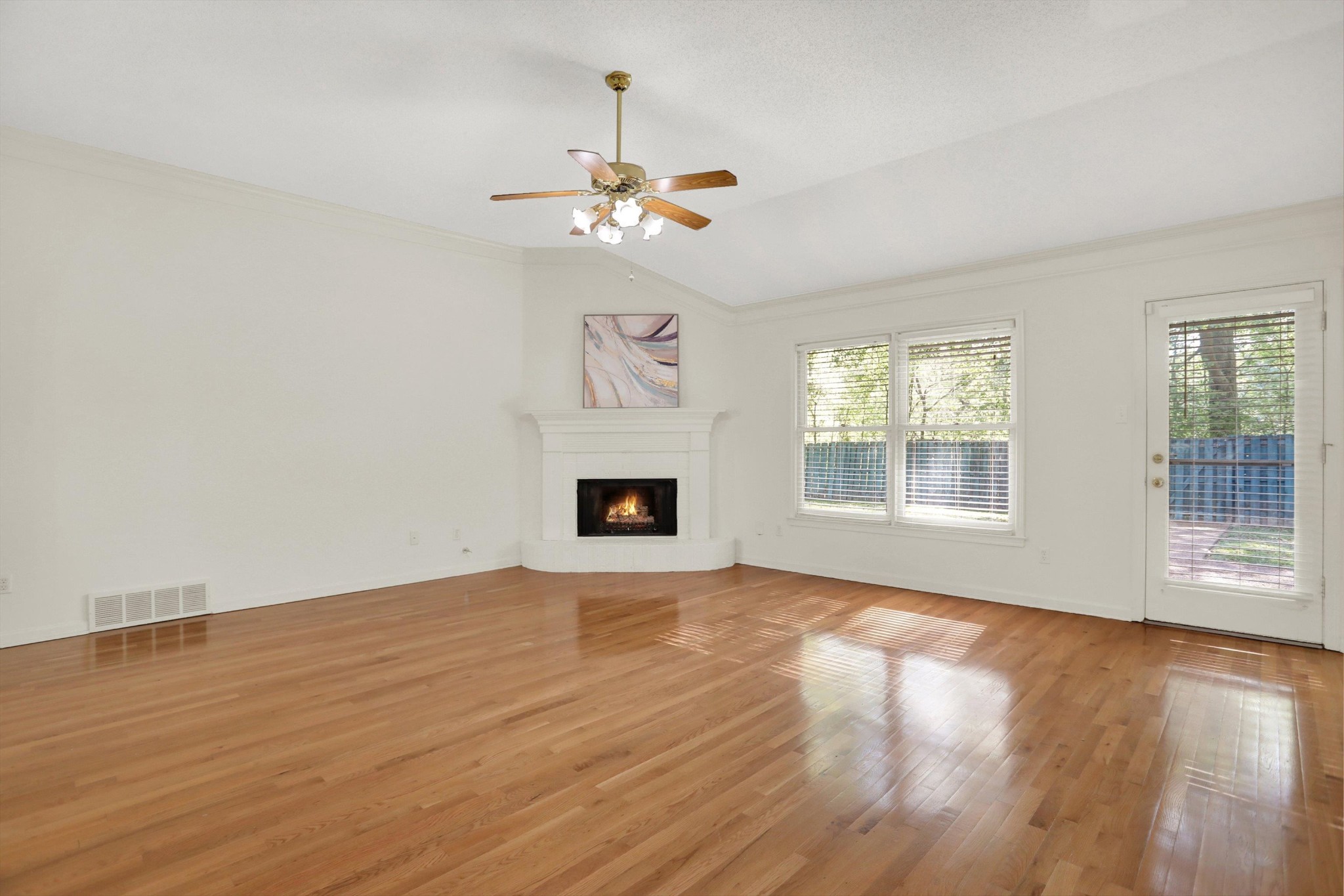 1130 Sugar Lane Collierville, TN 38017 - Photo 6 of 29 a view of an empty room with wooden floor fireplace and a window