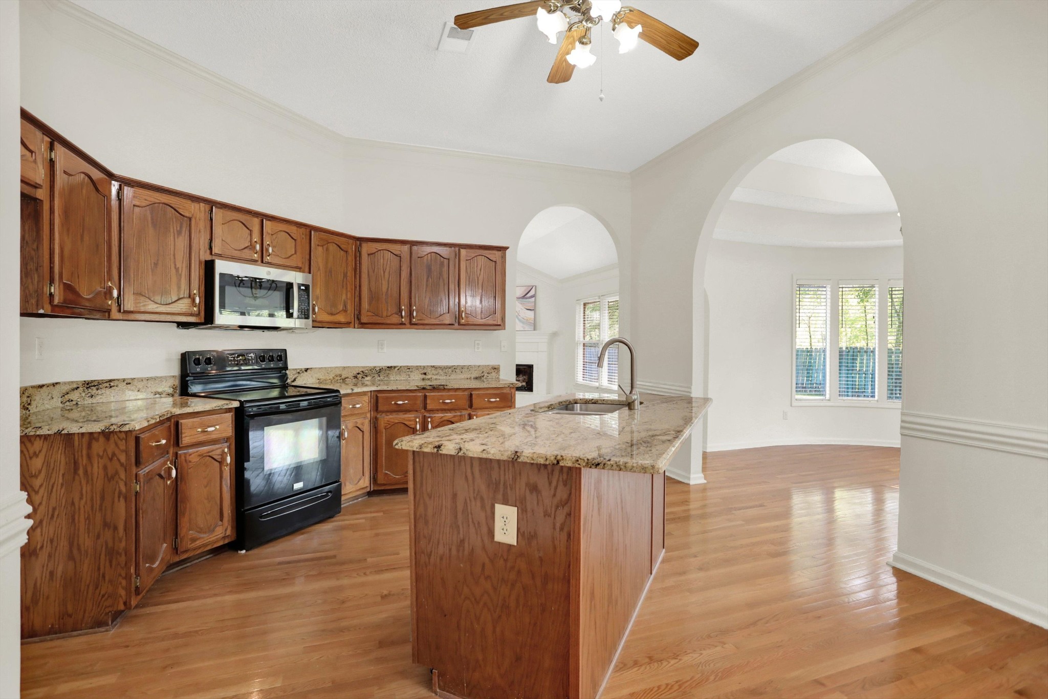1130 Sugar Lane Collierville, TN 38017 - Photo 10 of 29 a kitchen with stainless steel appliances granite countertop a sink stove and wooden cabinets