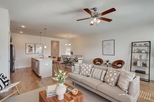 a living room with furniture and wooden floor
