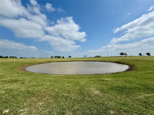 a view of a swimming pool and a yard