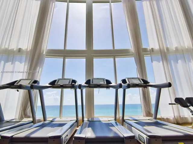 a view of staircase with white walls and a window