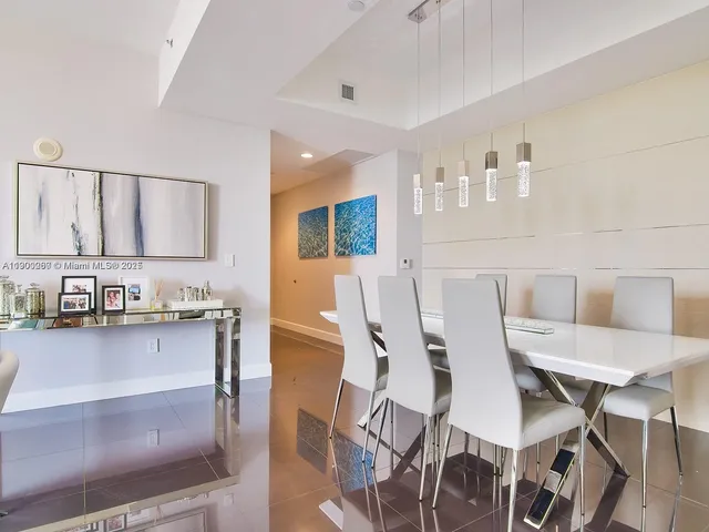 a kitchen with granite countertop a table chairs stove and cabinets