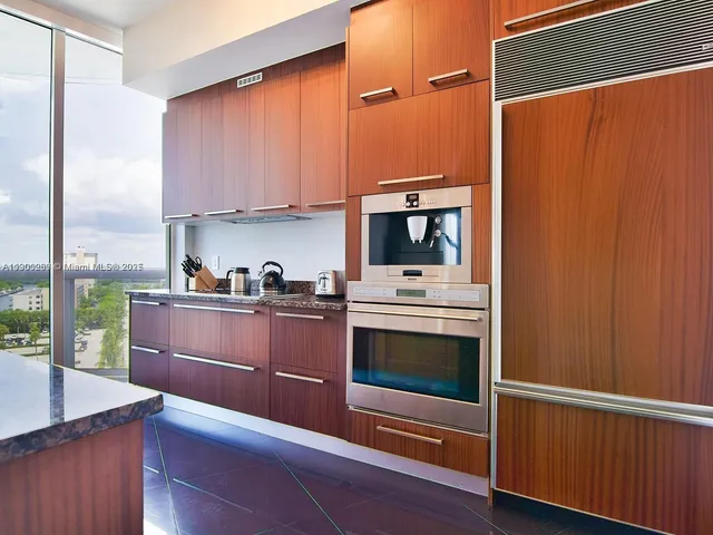 a kitchen with stainless steel appliances wooden cabinets and a stove top oven