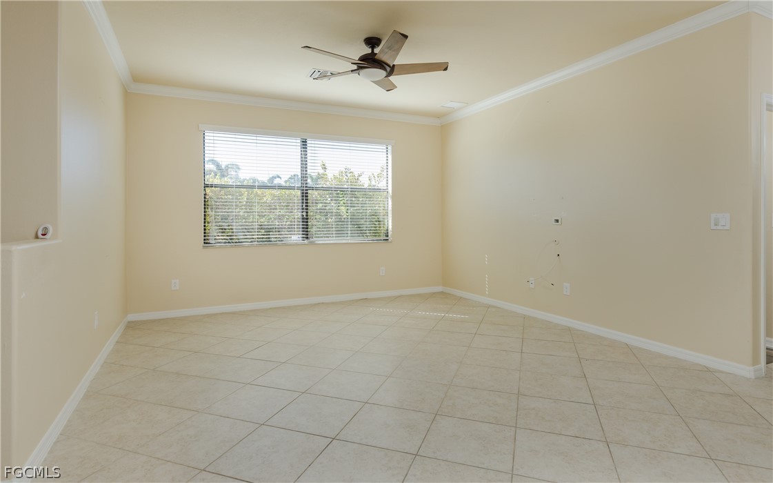 12906 Pastures Way Fort Myers, FL 33913 - Photo 11 of 44 an empty room with chandelier fan and windows