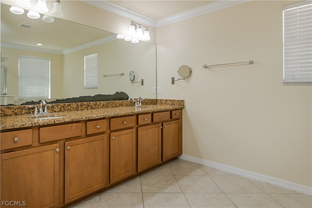 12906 Pastures Way Fort Myers, FL 33913 - Photo 18 of 44 a spacious bathroom with a granite countertop sink and a mirror