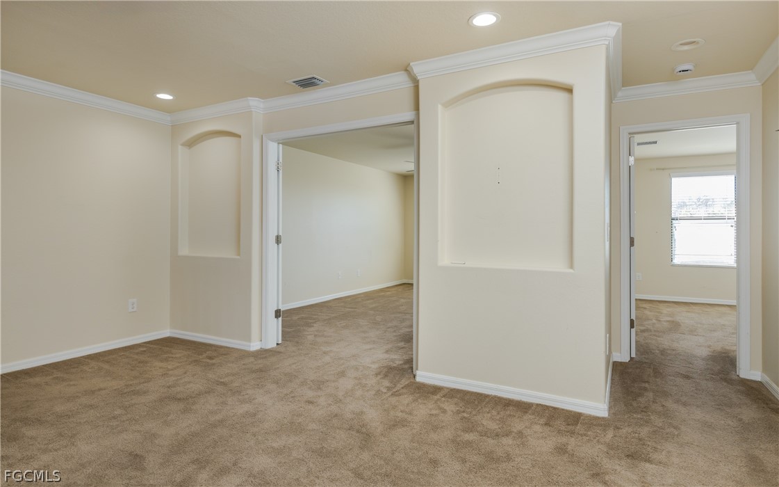 12906 Pastures Way Fort Myers, FL 33913 - Photo 19 of 44 an empty room with closet and wooden door