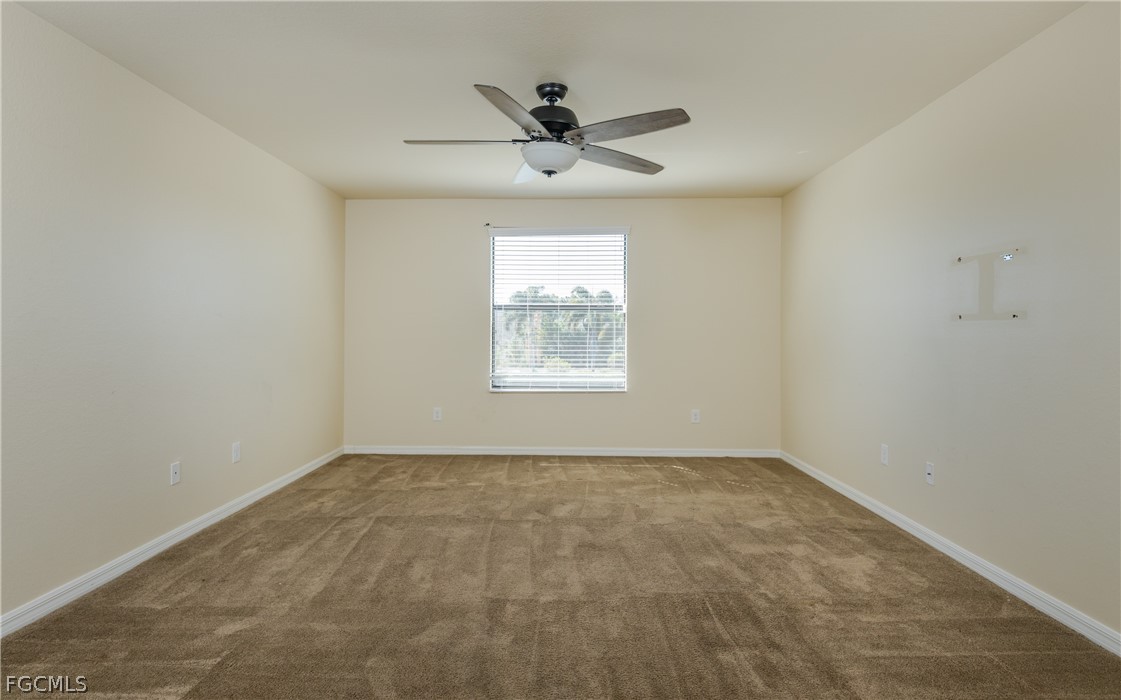 12906 Pastures Way Fort Myers, FL 33913 - Photo 20 of 44 an empty room with a window and a ceiling fan
