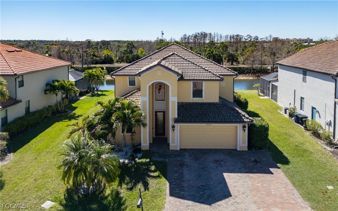 12906 Pastures Way Fort Myers, FL 33913 - Photo 2 of 44 a front view of a house with a garden
