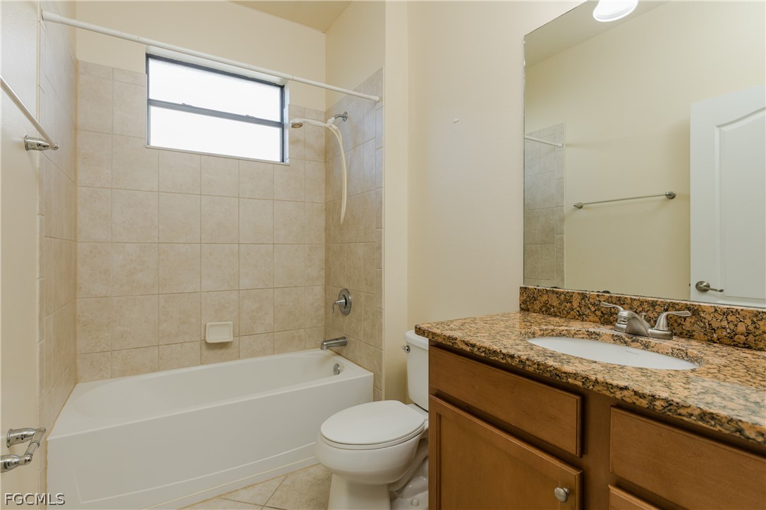12906 Pastures Way Fort Myers, FL 33913 - Photo 21 of 44 a bathroom with a granite countertop sink a toilet and bathtub