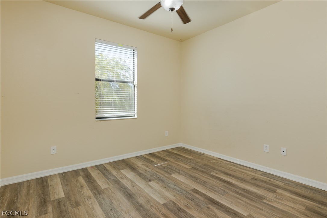 12906 Pastures Way Fort Myers, FL 33913 - Photo 22 of 44 an empty room with a window and a ceiling fan