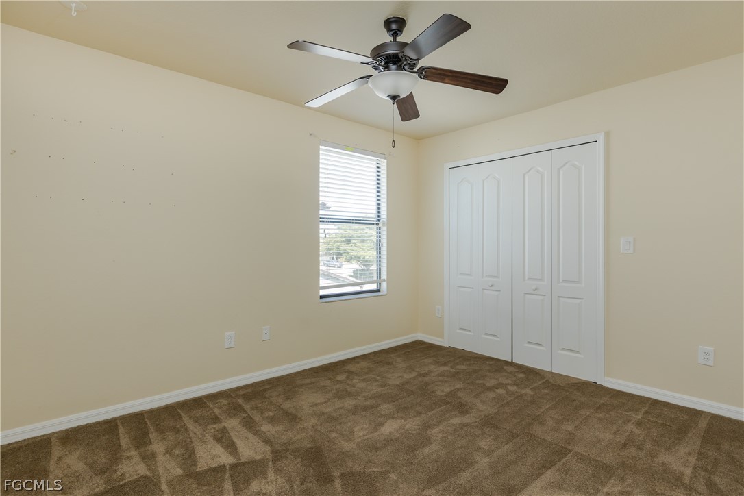 12906 Pastures Way Fort Myers, FL 33913 - Photo 24 of 44 an empty room with a window and a fan