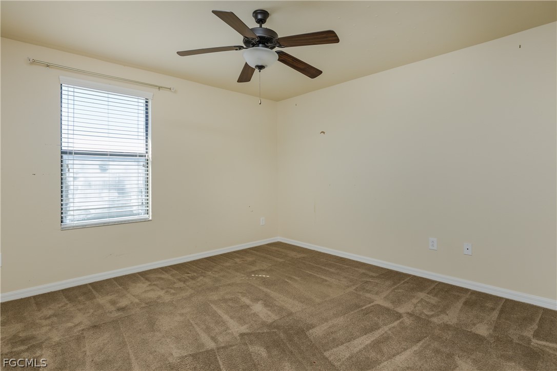 12906 Pastures Way Fort Myers, FL 33913 - Photo 26 of 44 an empty room with a window and a fan