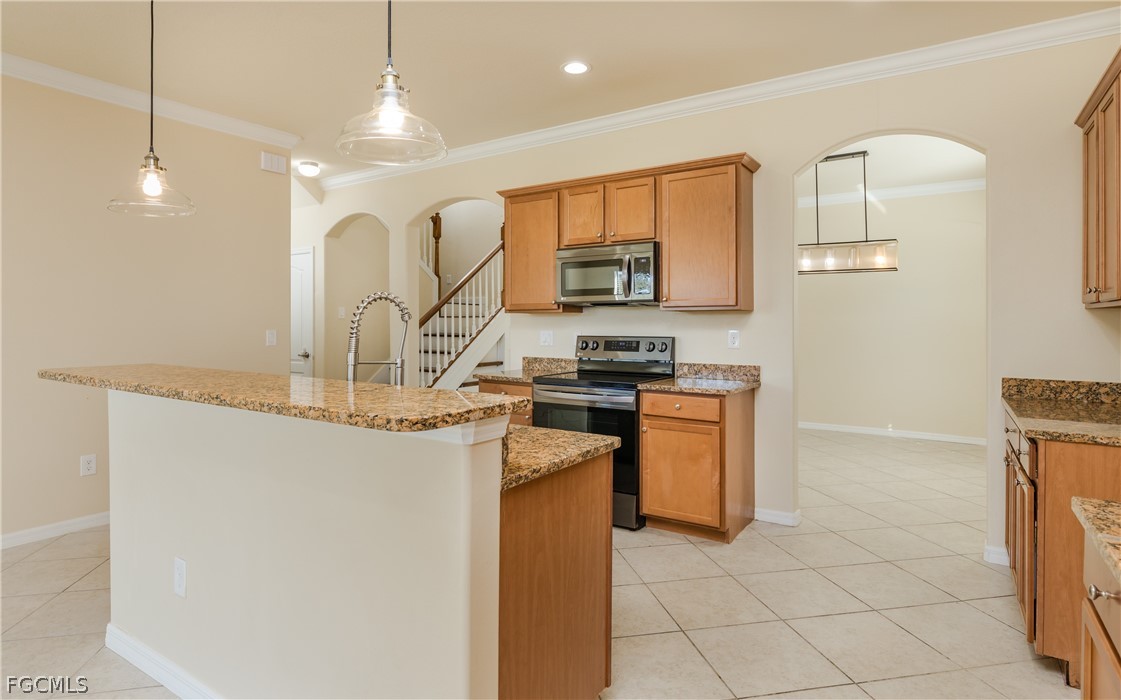 12906 Pastures Way Fort Myers, FL 33913 - Photo 6 of 44 a kitchen with stainless steel appliances granite countertop a stove a sink and a refrigerator