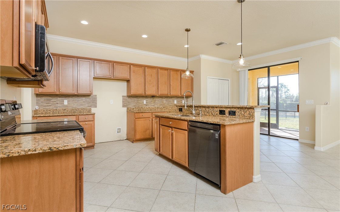12906 Pastures Way Fort Myers, FL 33913 - Photo 7 of 44 a kitchen with stainless steel appliances granite countertop a stove top oven a sink and a refrigerator