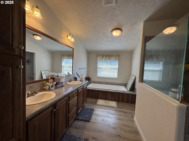 a kitchen with a sink and wooden floor
