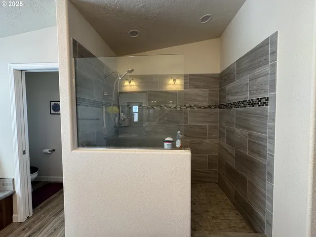 a bathroom with a shower and a sink