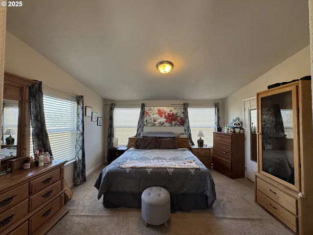 a bed sitting in a bedroom and next to a window