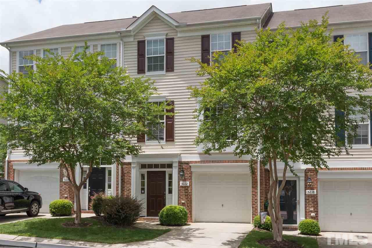 5222 Echo Ridge Road Raleigh, NC 27612 - Photo 1 of 25 a front view of a house with a yard and garage