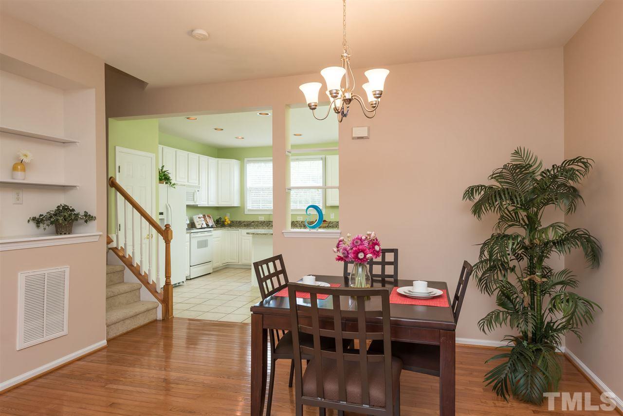 5222 Echo Ridge Road Raleigh, NC 27612 - Photo 12 of 25 a view of a dining room with furniture and wooden floor
