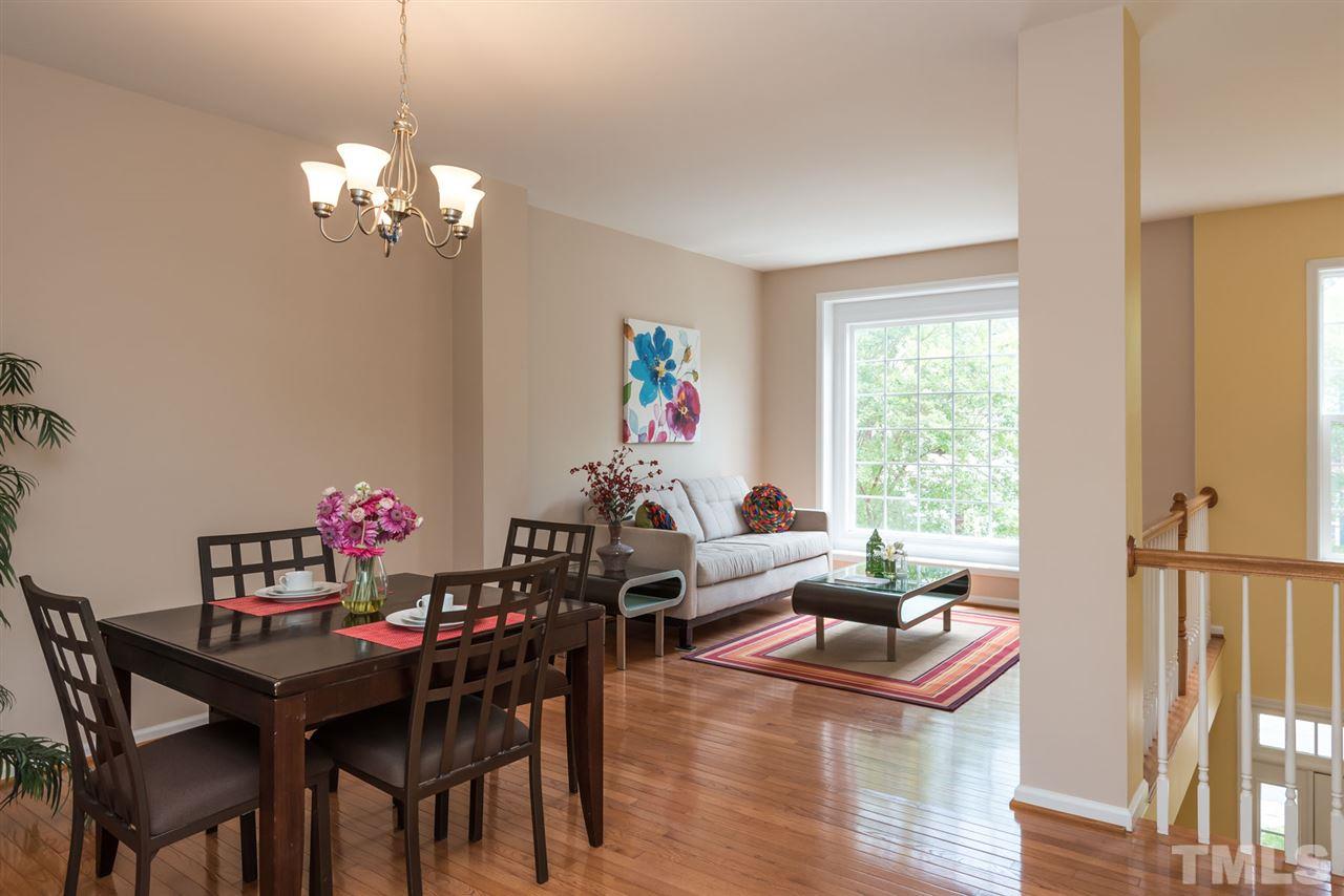5222 Echo Ridge Road Raleigh, NC 27612 - Photo 13 of 25 a view of a dining room with furniture a chandelier and wooden floor