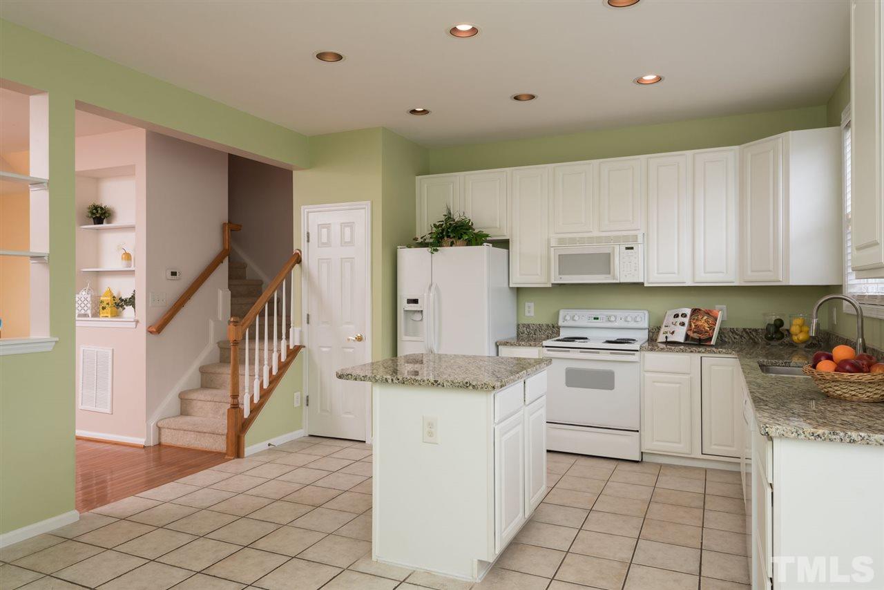 5222 Echo Ridge Road Raleigh, NC 27612 - Photo 16 of 25 a kitchen with a stove a sink and a refrigerator