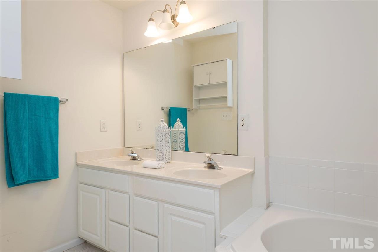 5222 Echo Ridge Road Raleigh, NC 27612 - Photo 20 of 25 a bathroom with a sink double vanity and a mirror