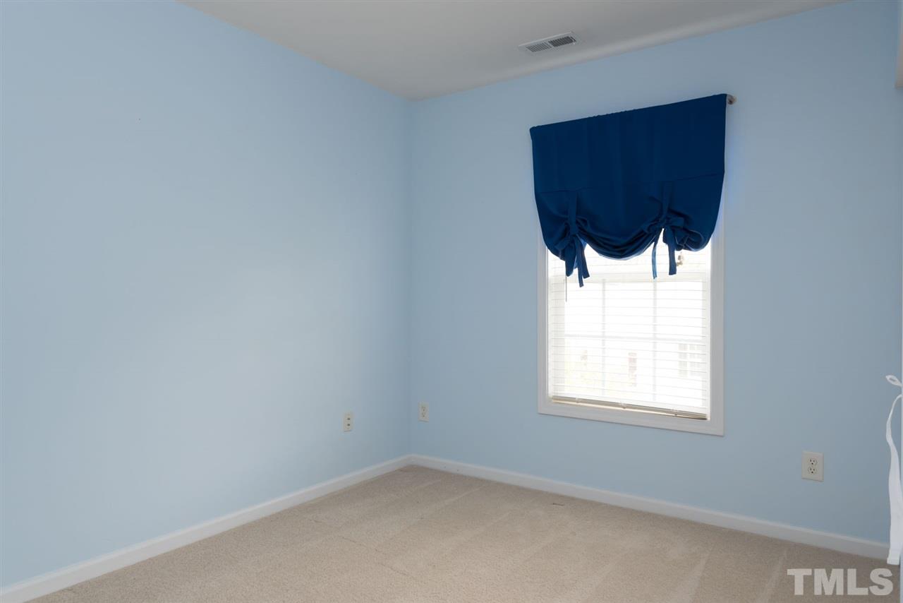 5222 Echo Ridge Road Raleigh, NC 27612 - Photo 23 of 25 an empty room with a window and wooden floor
