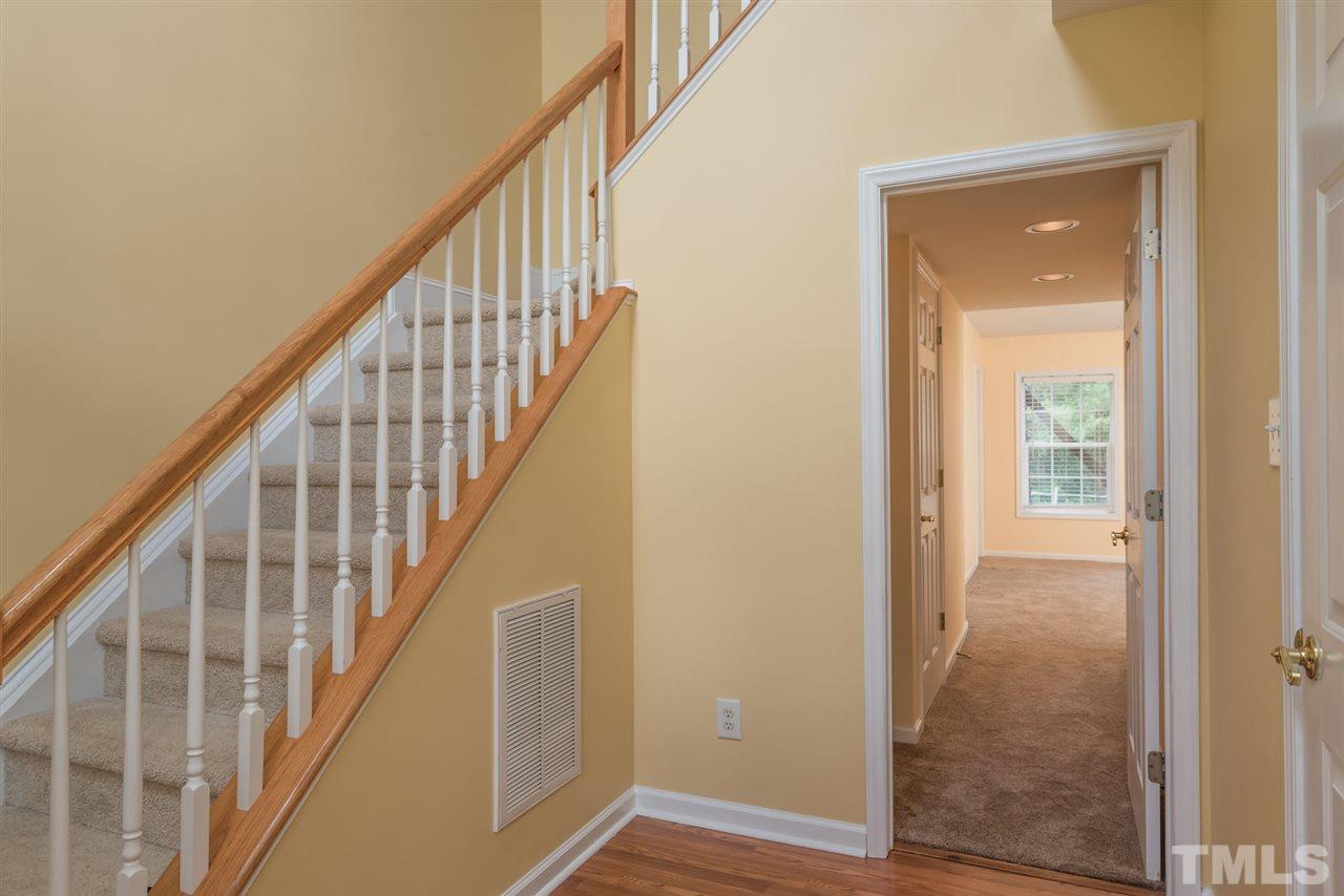 5222 Echo Ridge Road Raleigh, NC 27612 - Photo 4 of 25 a view of staircase with wooden floor and white walls