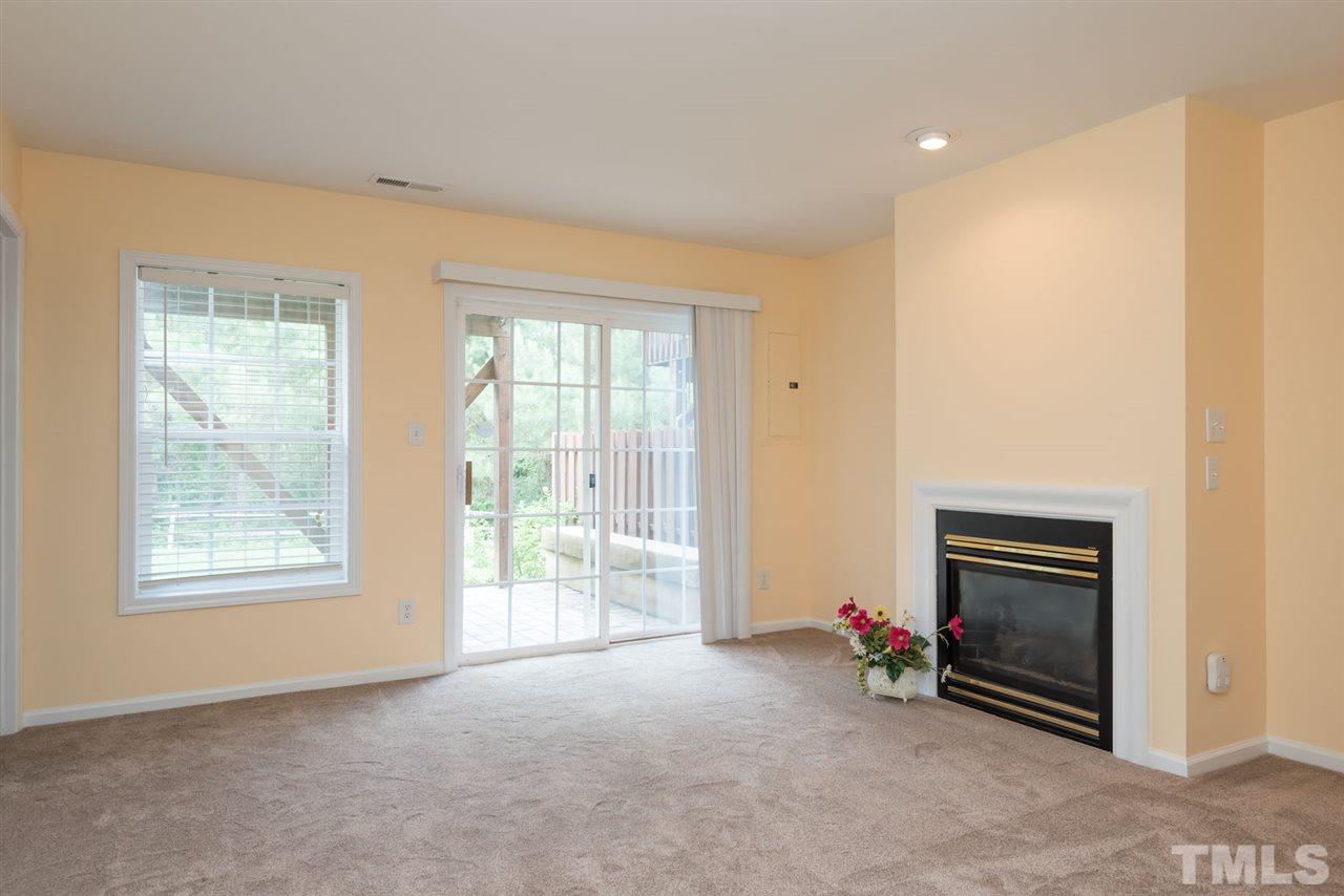 5222 Echo Ridge Road Raleigh, NC 27612 - Photo 5 of 25 an empty room with windows and fireplace
