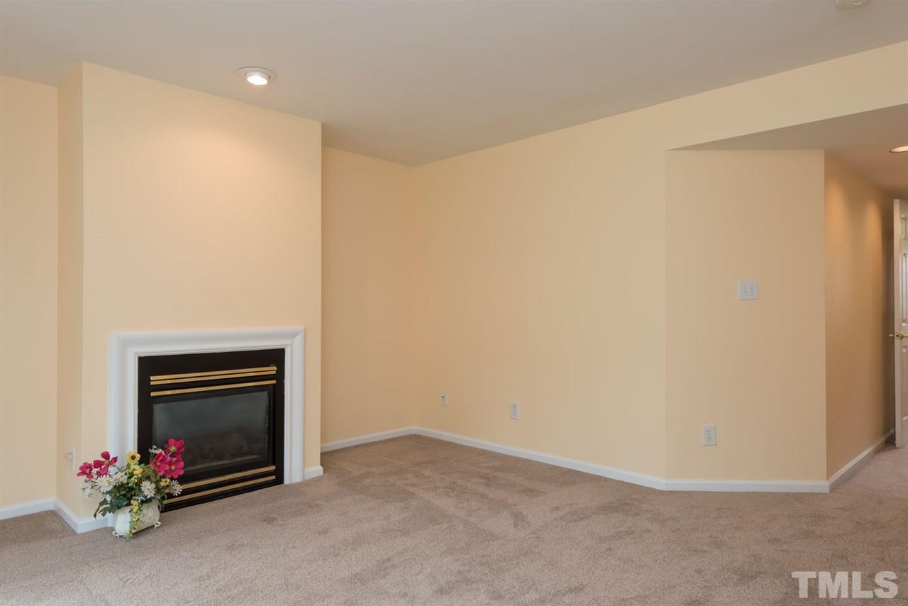 5222 Echo Ridge Road Raleigh, NC 27612 - Photo 6 of 25 a view of an empty room with a fireplace