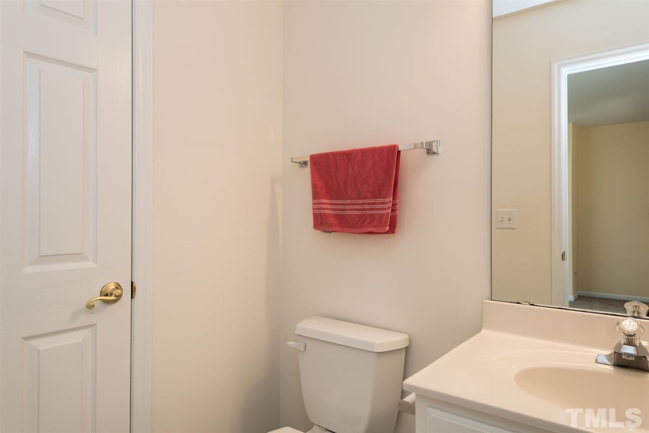 5222 Echo Ridge Road Raleigh, NC 27612 - Photo 7 of 25 a bathroom with a sink and a toilet