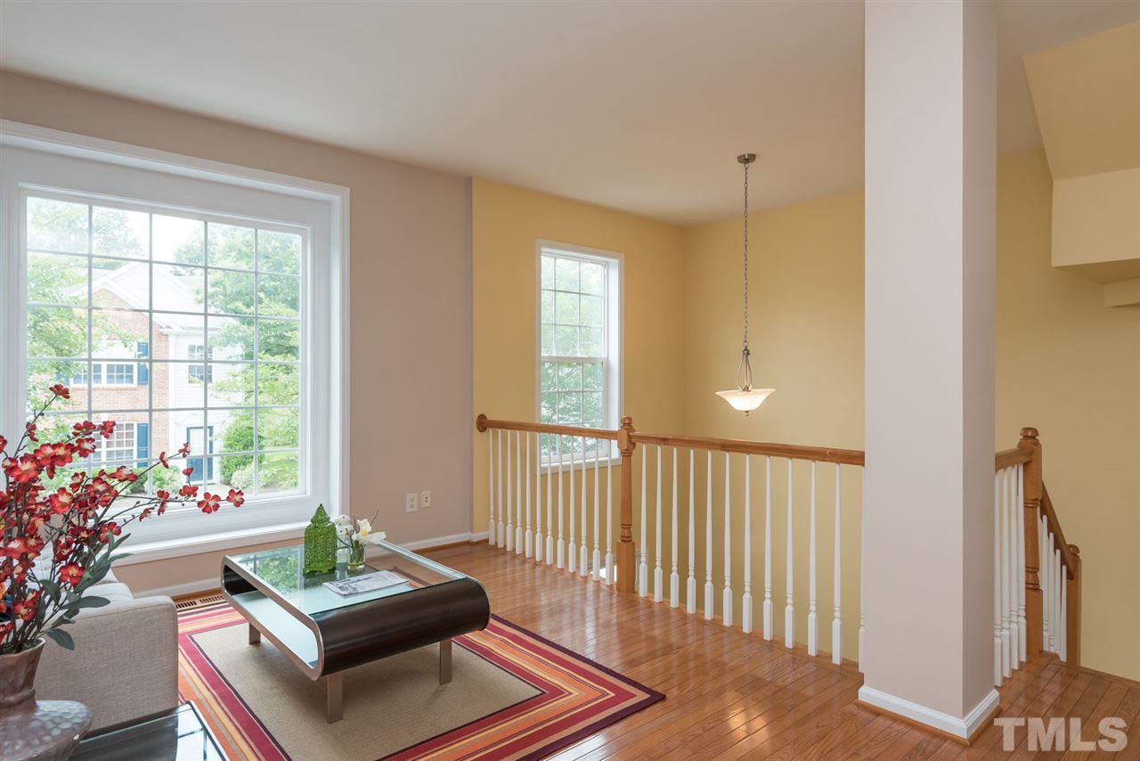 5222 Echo Ridge Road Raleigh, NC 27612 - Photo 9 of 25 a living room with furniture and a potted plant