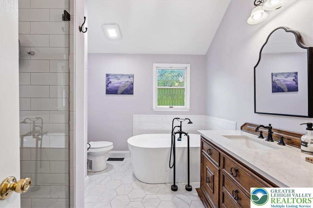 2011 Fieldview Drive Nazareth, PA 18064 - Photo 24 of 52 Step into a light-filled bathroom featuring a freestanding tub and ample vanity space.