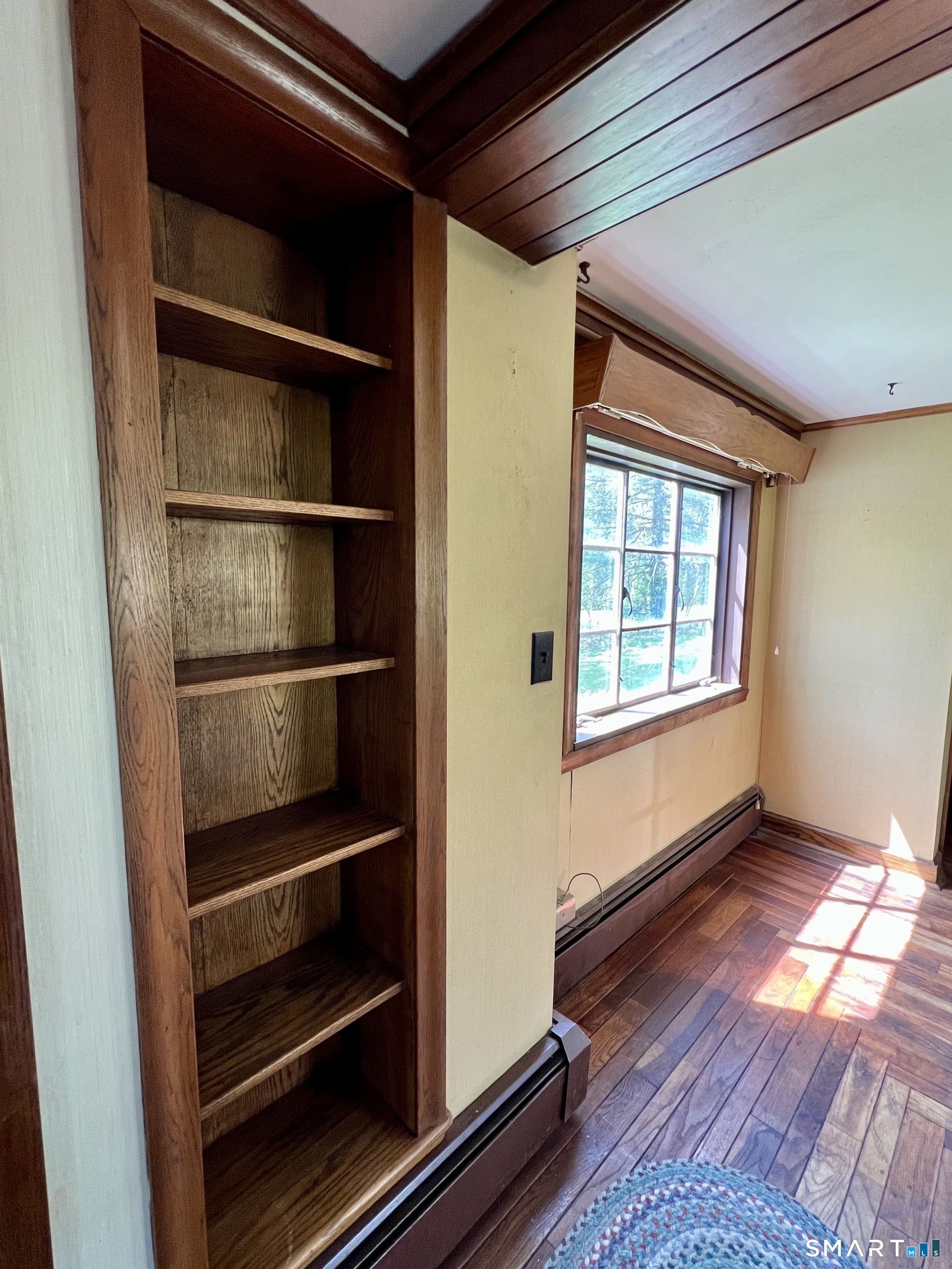 213 Hart Street Berlin, CT 06037 - Photo 17 of 40 a view of an empty room with wooden floor and a window