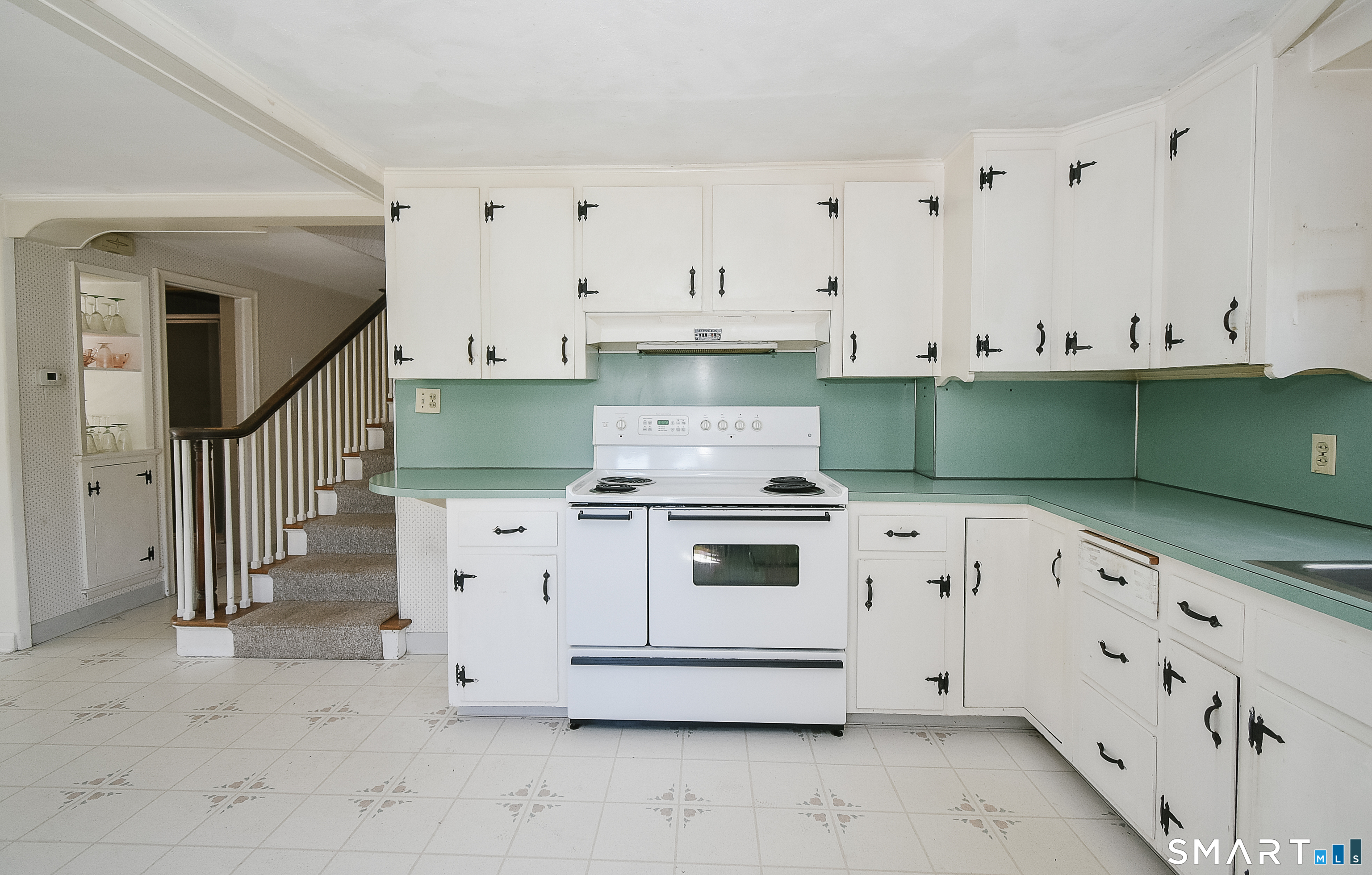 213 Hart Street Berlin, CT 06037 - Photo 30 of 40 a white kitchen with granite top and white stainless steel appliances