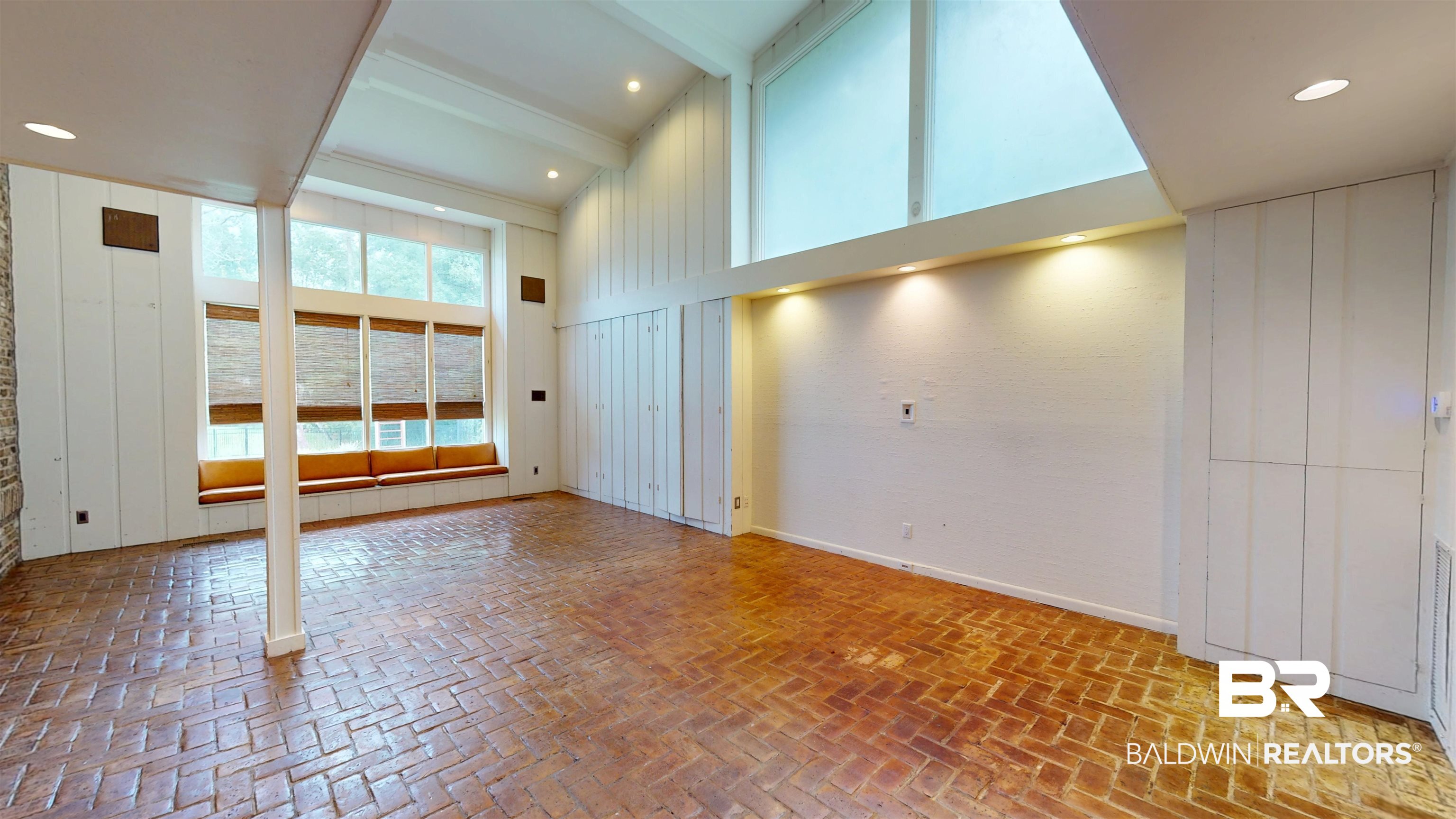 15 Spring Bank Road Mobile, AL 36608 - Photo 30 of 58 Unfurnished great room with brick flooring, a towering ceiling, and beam ceiling