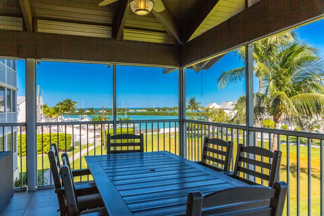 a view of a balcony with wooden floor and outdoor seating