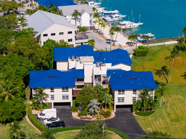 an aerial view of multiple houses with yard
