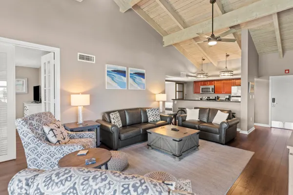 a living room with furniture ceiling fan and a rug