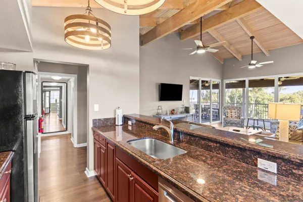 a kitchen with stainless steel appliances granite countertop a sink and a wooden floors