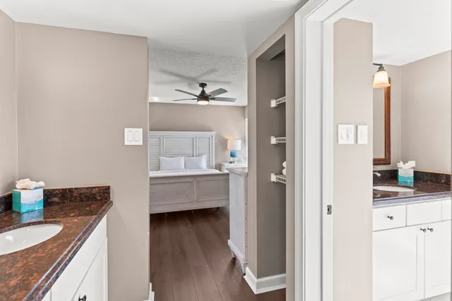 a en suite bathroom with a granite countertop sink and a mirror