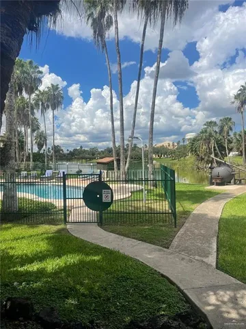 a view of a park and iron fence