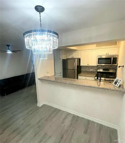 a view of dining room with furniture and chandelier