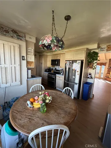 a view of a dining room with furniture wooden floor and chandelier