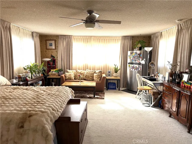 a bed room with a bed and a chandelier