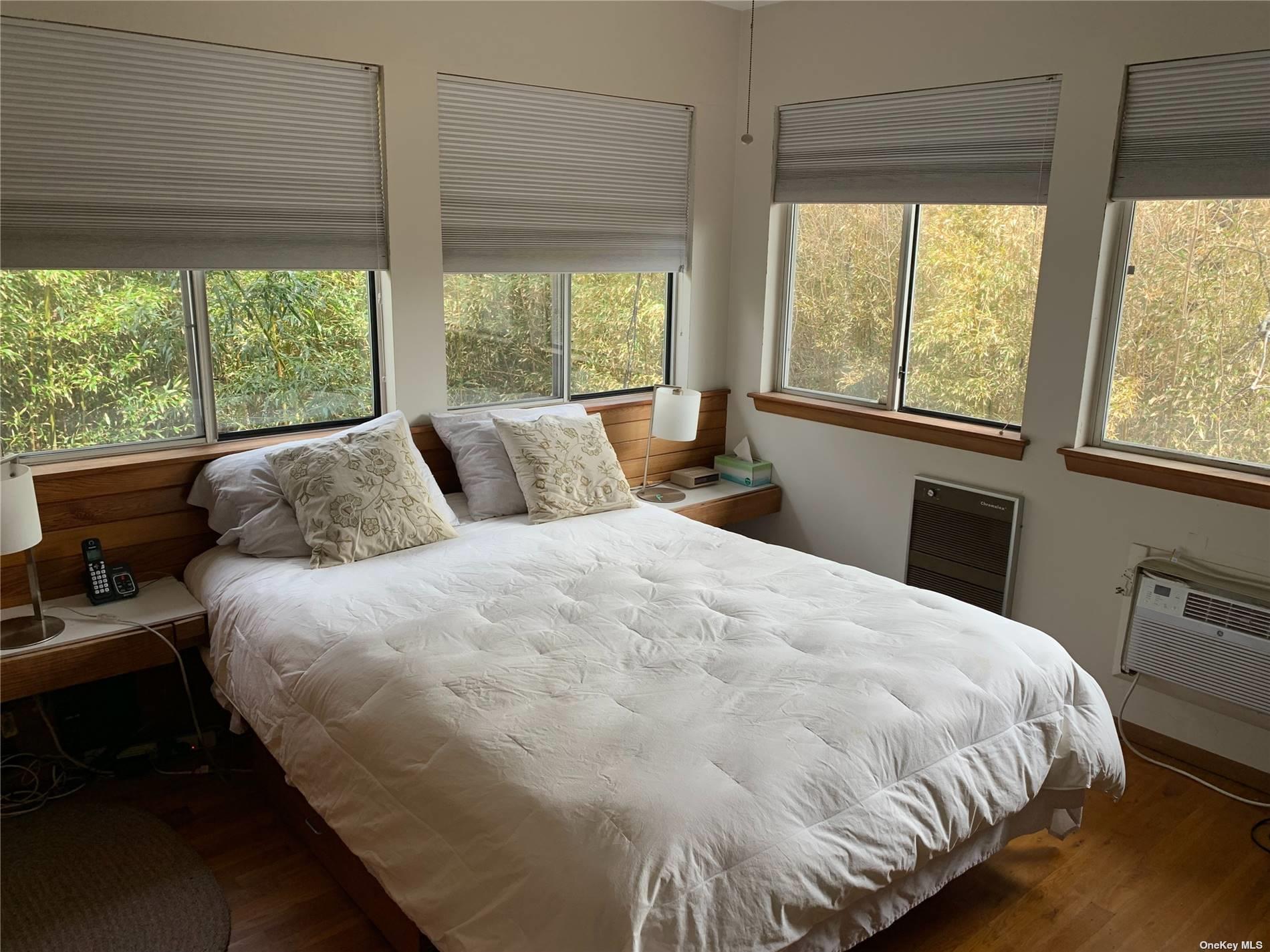 6 Sloop Walk Ocean Beach, NY 11770 - Photo 6 of 11 a large bed sitting in a bedroom next to a window