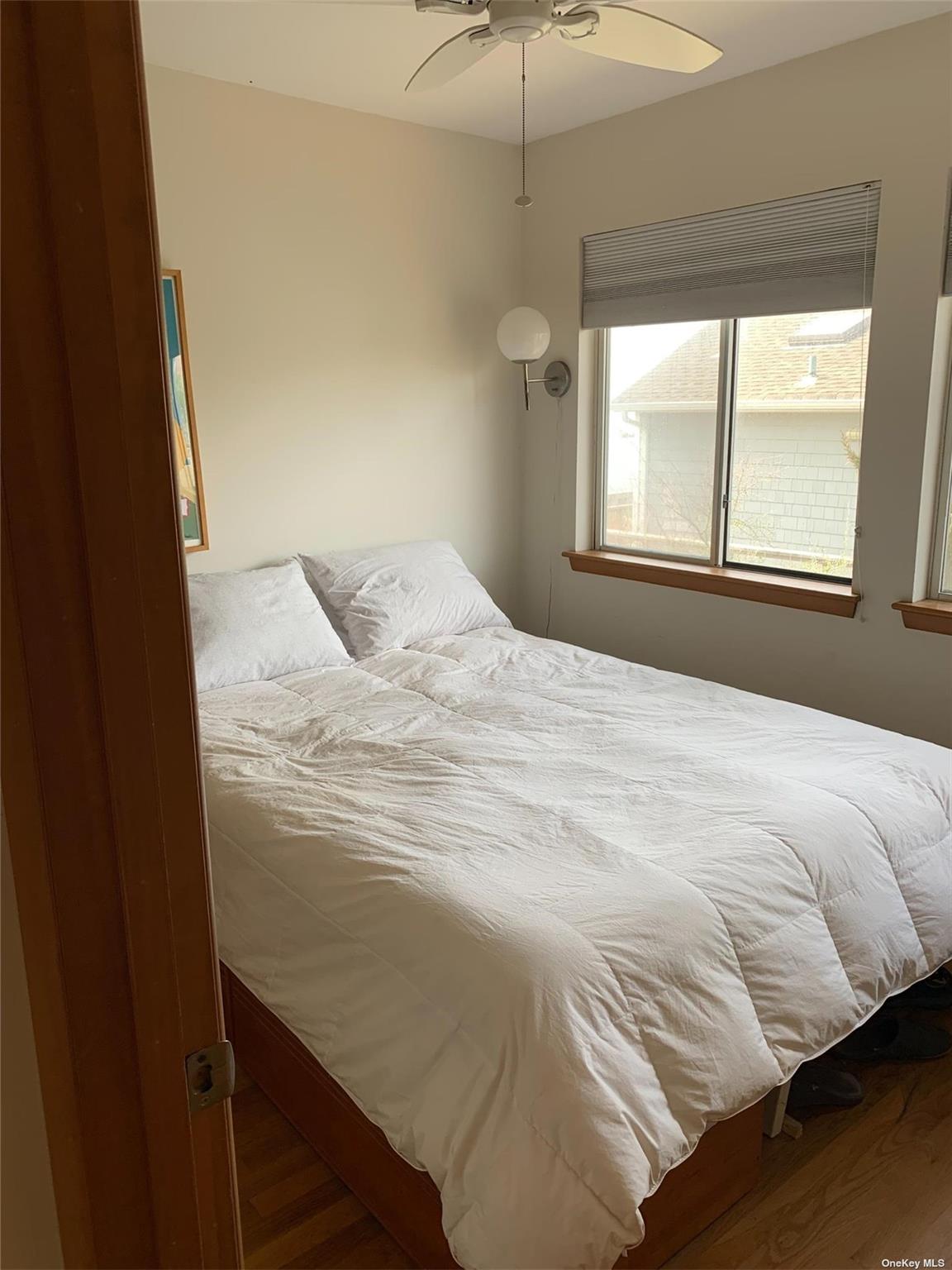 6 Sloop Walk Ocean Beach, NY 11770 - Photo 9 of 11 a bedroom with a bed and a window