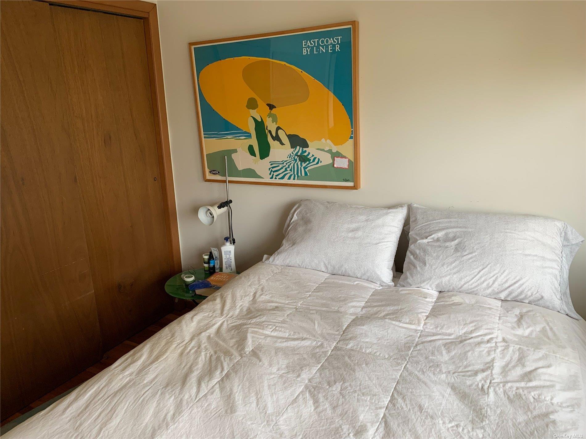 6 Sloop Walk Ocean Beach, NY 11770 - Photo 10 of 11 a bed sitting in a bedroom next to a window