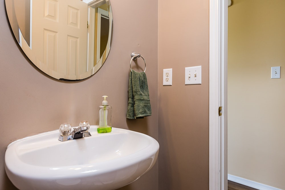 Tucked aside for privacy with it's own window overlooking the back yard. Powder Room